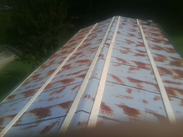 Rusted metal roof panels with new wood purlins before replacement — Storm Damage Roof Repair in Jbsa Lackland by Roofing Brothers